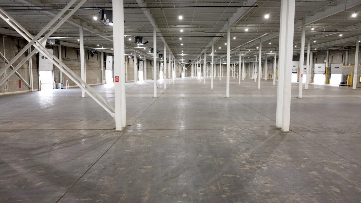 Large open warehouse interior with long sightlines and high bay racking structure